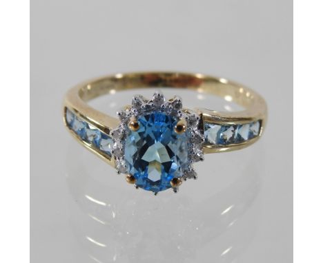 A 9 carat blue topaz and diamond ring, boxed