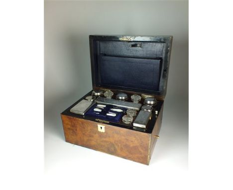 A late 19th century travelling vanity set, comprising; eight silver plated glass jars/bottle, four cut glass bottles and a ma