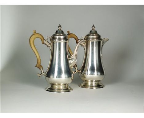 A Queen Anne style silver coffee pot and hot water jug, C J Vander, London 1966, each with turned wood handle and urn finial 