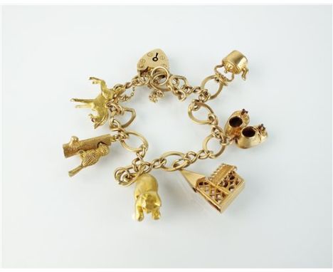 A 9ct gold charm bracelet, with attached 9ct gold and yellow metal charms, to include; a kitten playing with a pearl ‘ball’, 