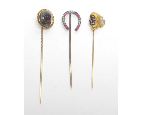 Three 19th Century tie pins, comprising: a dog pattern intaglio within twisted border, 8.3cms high; a diamond and ruby horses