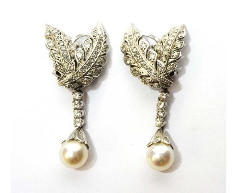 A fine pair of diamond and cultured pearl earrings, each in the form of diamond-set leaves, holding a detachable drop of diam
