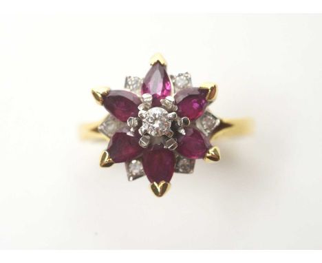 A ruby and diamond ring, set with central brilliant cut diamond surrounded by six pear-cut rubies and six eight-cut diamonds 