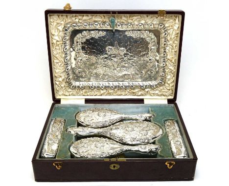 An Edwardian silver dressing table set, by William Neale, Chester, 1901, comprising: tray, hand mirror, a pair of hairbrushes