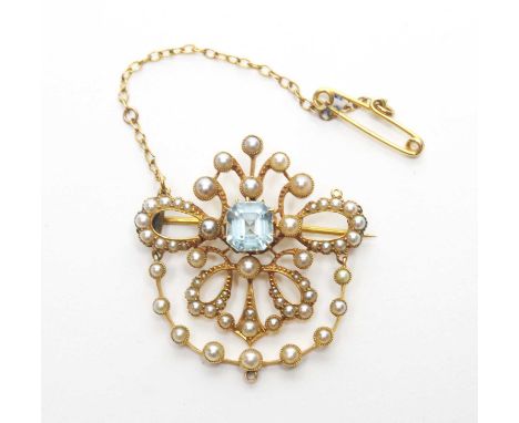 An Edwardian aquamarine and seed pearl brooch, the central canted square step-cut aquamarine surrounded by graduated seed pea
