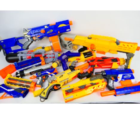 Nerf - Toy Guns. A selection of Nine loose predominantly Nerf Guns and accessories and One Light Saber appearing in Excellent