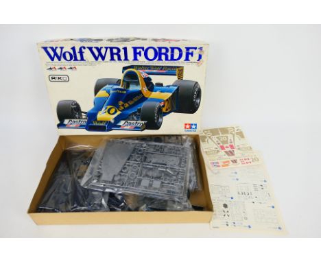 Tamiya - A boxed Tamiya BS1224 1:12 scale Wolf WR1 Ford F1 plastic model kit. The 1977 model kit appears Mint and has loose p