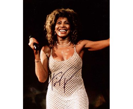 TURNER TINA: (1939-2023) American singer. Signed colour 8 x 10 photograph of Turner standing in a happy three-quarter length 