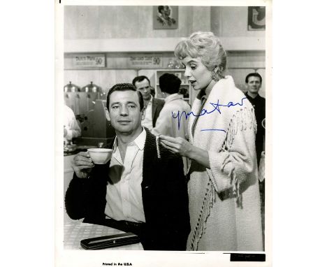 MONTAND YVES: (1921-1991) French actor. Vintage signed 8 x 10 photograph of Montand seated at a table in a half-length pose, 