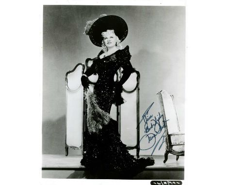 WEST MAE: (1893-1980) American actress and sex symbol. Signed and inscribed 8 x 10 photograph of West standing in a glamourou