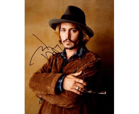 DEPP JOHNNY: (1963- ) American actor. Signed colour 8 x 10 photograph of Depp standing in a half-length pose wearing a hat an