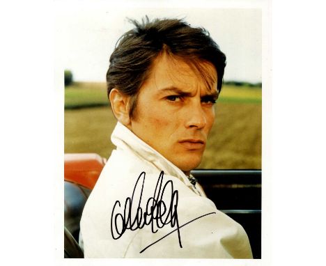 DELON ALAIN: (1935- ) French Actor. A good signed 8 x 10 colour photograph, the image showing Delon seated in his convertible