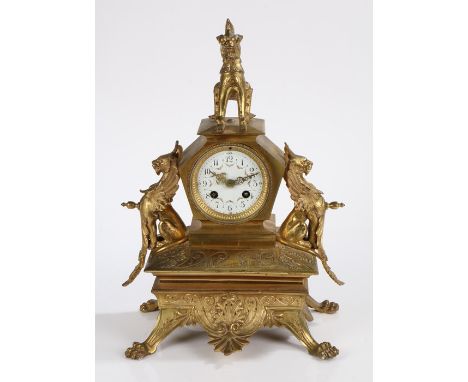 Late 19th Century gilt metal French mantel clock, surmounted by a Chinese style dragon above the shaped case flanked by a gri