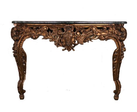 Marble and giltwood console table, the serpentine marble top above a carved shield flanked by feathers and foliate carved and