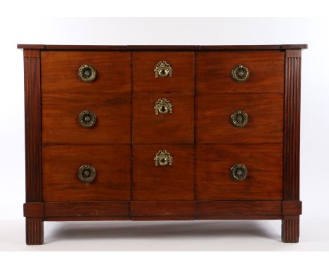 Early 19th Century Dutch mahogany commode, of shallow breakfront form, having three graduated long drawers, and stop-fluted f