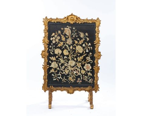 19th Century gilt gesso fire screen, the shell and scroll frame enclosing the foliate silk panel, 58.5cm wide, 94cm high