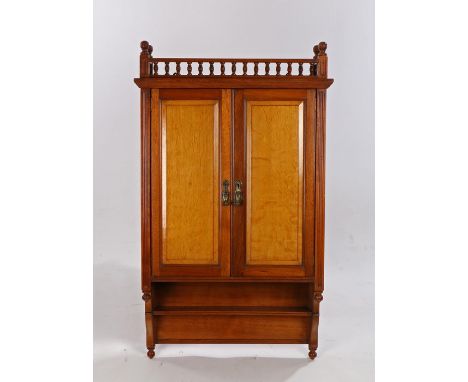 Gillows &amp; Co oak and mahogany wall cabinet, the pierced gallery above two panelled cupboard doors opening to reveal two s