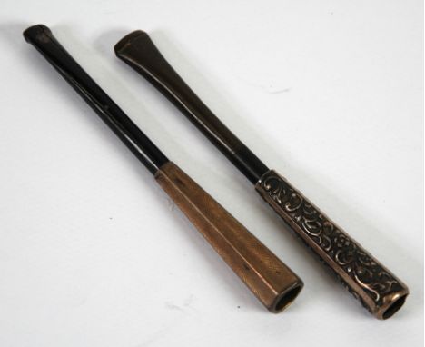 ENGINE TURNED GILT STERLING HEXAGONALLY PANELLED CIGARETTE HOLDER with spring loaded ejector and ebony mount piece and a SILV