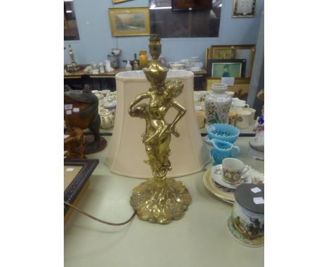 A LARGE ART NOUVEAU STYLE BRASS FEMALE FIGURE TABLE LAMP ON CIRCULAR LEAF AND FLORAL PATTERN BASE, 17" HIGH AND THE CREAM SIL