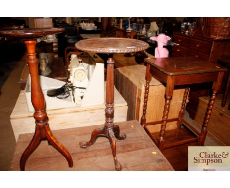 A carved mahogany tripod wine table