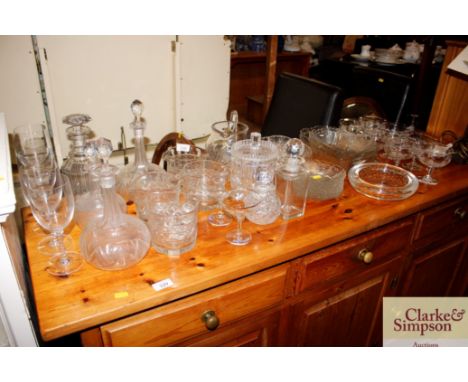 A collection of various table glassware to include cut glass finger bowls, fruit bowls, side plates, decanters etc.