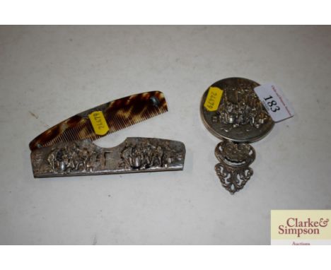A continental white metal hand mirror with figural decoration; and a matching comb