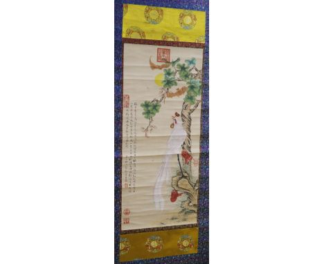 A Chinese scroll painting of a phoenix in a landscape