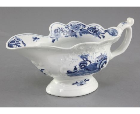 A Worcester Triangular Platform pattern blue and white sauceboat, c.1755, the crest moulded wavy edged sauceboat with C-shape