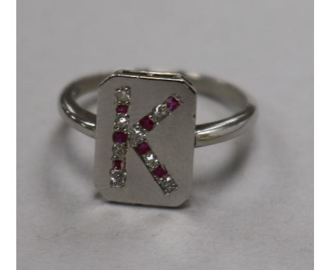 A platinum, ruby and diamond set initial ring, size K.