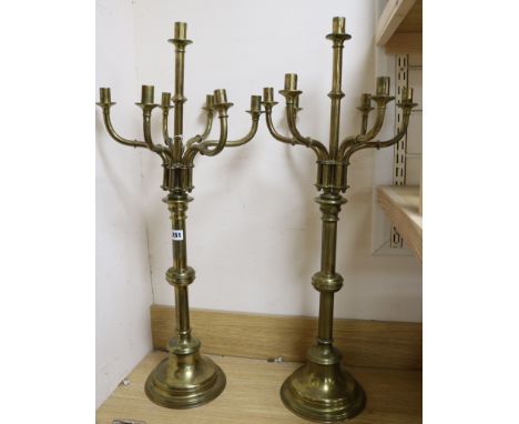 A pair of Victorian brass seven-light candlesticks, with detachable candle arms, H 82cm