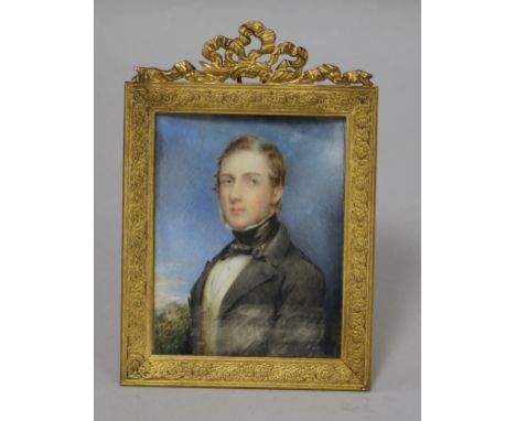 A 19th century rectangular miniature portrait of a young gentleman, watercolour on ivory, portrayed half-length in a landscap