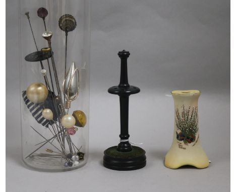 A collection of hatpins, two hatpin stands, one Carlton Ware, one treen and a velvet evening bag embroidered with a peacock i