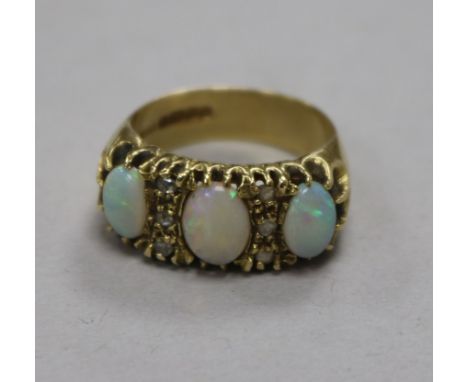 An 18ct gold, white opal and diamond set ring, size P.