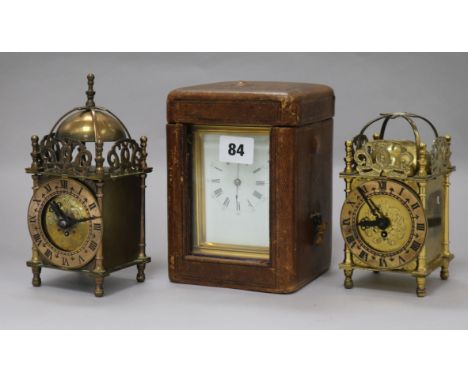 A cased carriage clock and two small lantern clocks