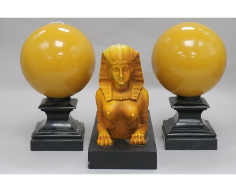 An Art Deco style composition group of a sphinx and two spheres