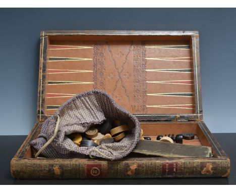 Leather "Two Volume" folding games board, wooden chess pieces and draughts and a slide rule.
