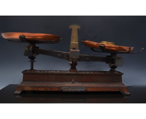 Set of French balance scales, labelled B Treyvou, with copper pans and three nesting brass weights, width overall, 49cm.
