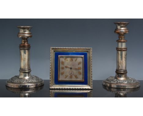 Plated and enamel strut clock, square dial, eight day movement, 12cm and a pair of plated telescopic candlesticks (3).