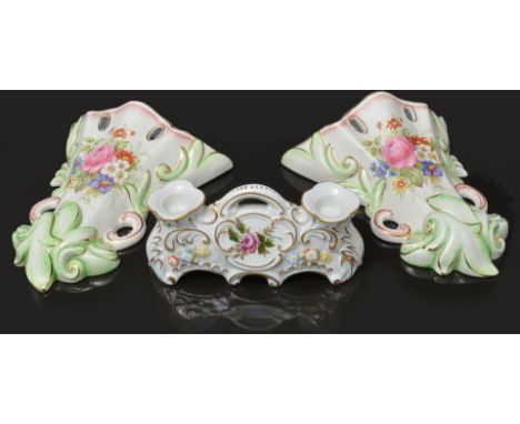 Continental porcelain figural candlestick, designed with a cherub holding a cornucopia, restored, 33cm, a German porcelain do