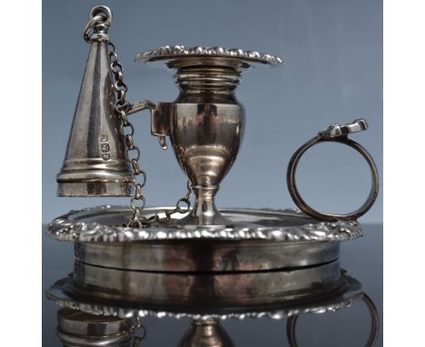 George III silver chamber stick, London 1818, urn shape sconce, gadrooned and shell outline with a conical snuffer, height 5.