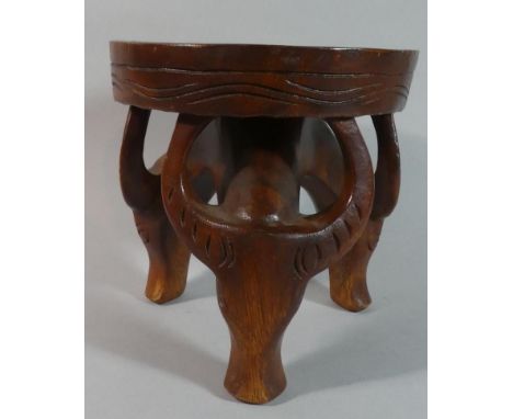 An Ethnic Circular Topped Stool with Tripod Supports in the Form of Water Buffalo Heads, 20.5cm Diameter 