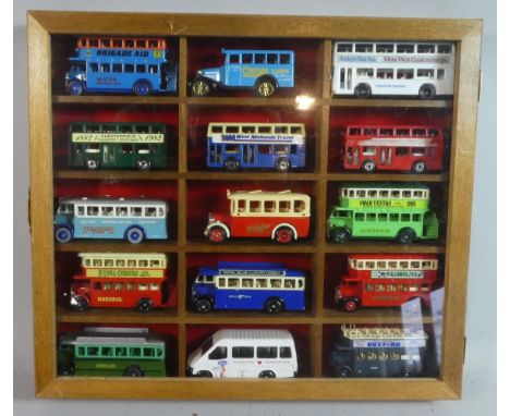 A Glazed Wooden Display Containing 15 Diecast Models of Vintage Buses 