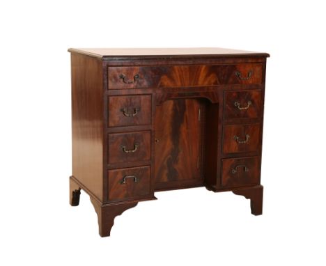 A George III style crossbanded mahogany kneehole desk, the quarter veneered top with moulded edge, over a long drawer above a