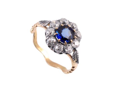 A sapphire and diamond ring, circa 1880-1890, the round mixed cut sapphire nine claw set within a surround of nine old brilli