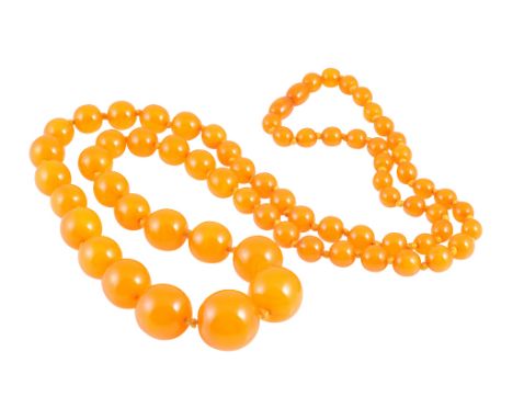 An amber coloured bead necklace, the sixty nine graduating amber-coloured beads threaded knotted with a double sided amber sc