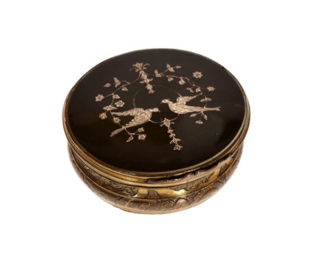 A brass and inlaid tortoiseshell snuff box, the circular hinged cover inlaid with white metal to depict two birds and meander