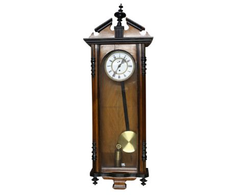 A 19th Century walnut and ebonised Vienna wall clock, with single train movement, the white enamel dial with Roman numerals. 
