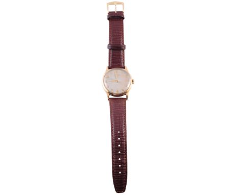A gentleman's 9 carat gold wristwatch, signed Longines, the circular dial with centre sweep seconds and Arabic numerals, on l