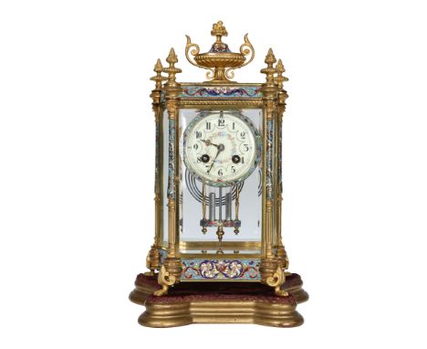 A late 19th Century French gilt brass and champleve enamel four glass mantel clock, the canted case with inverted bowed sides