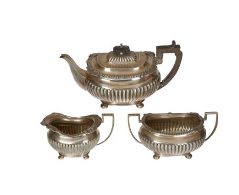 An Edwardian silver three-piece tea service, John Round, Sheffield 1904, comprising teapot, cream jug and two-handled sugar b